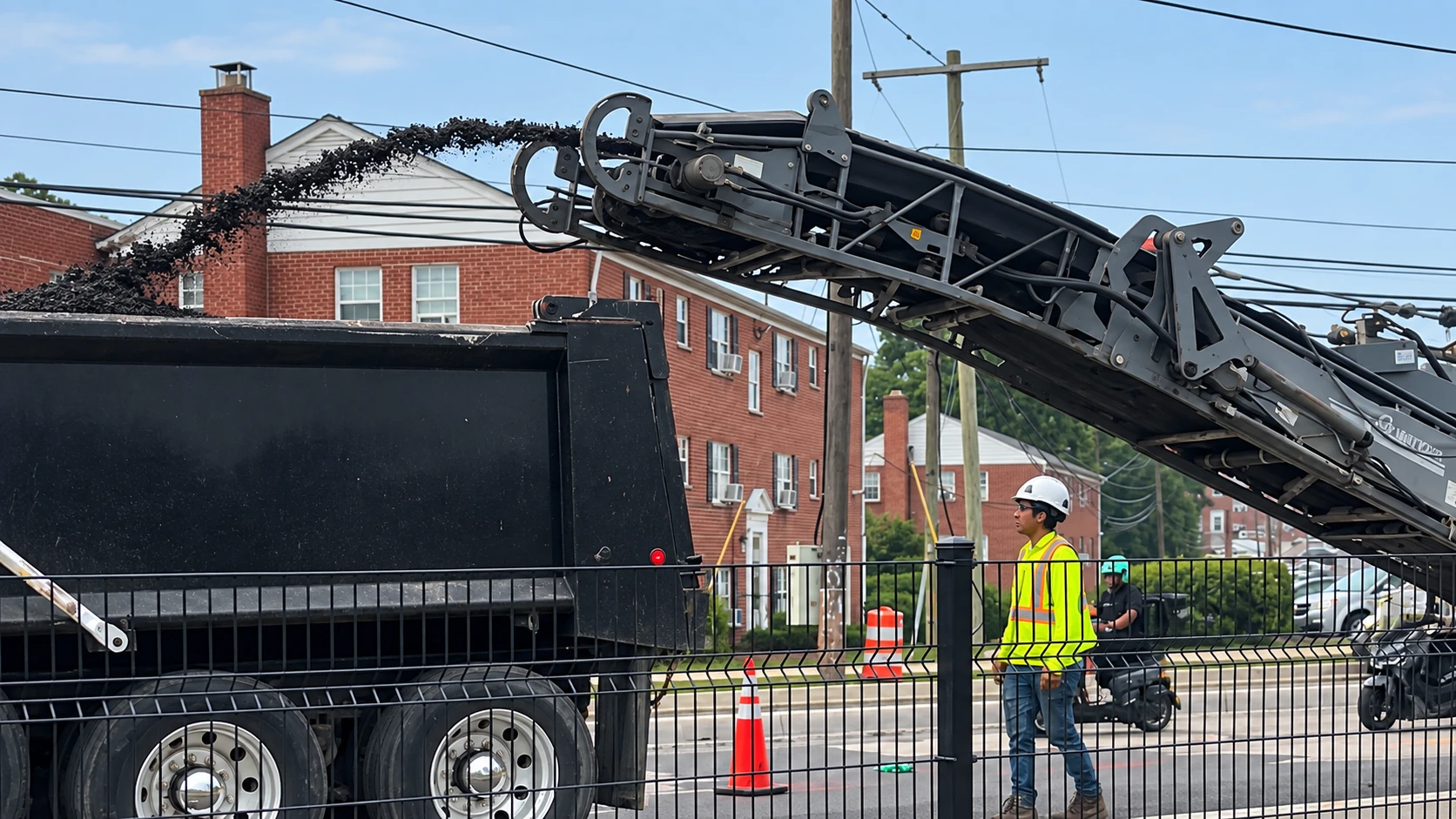 Milled asphalt being transferred from the milling machine into a truck