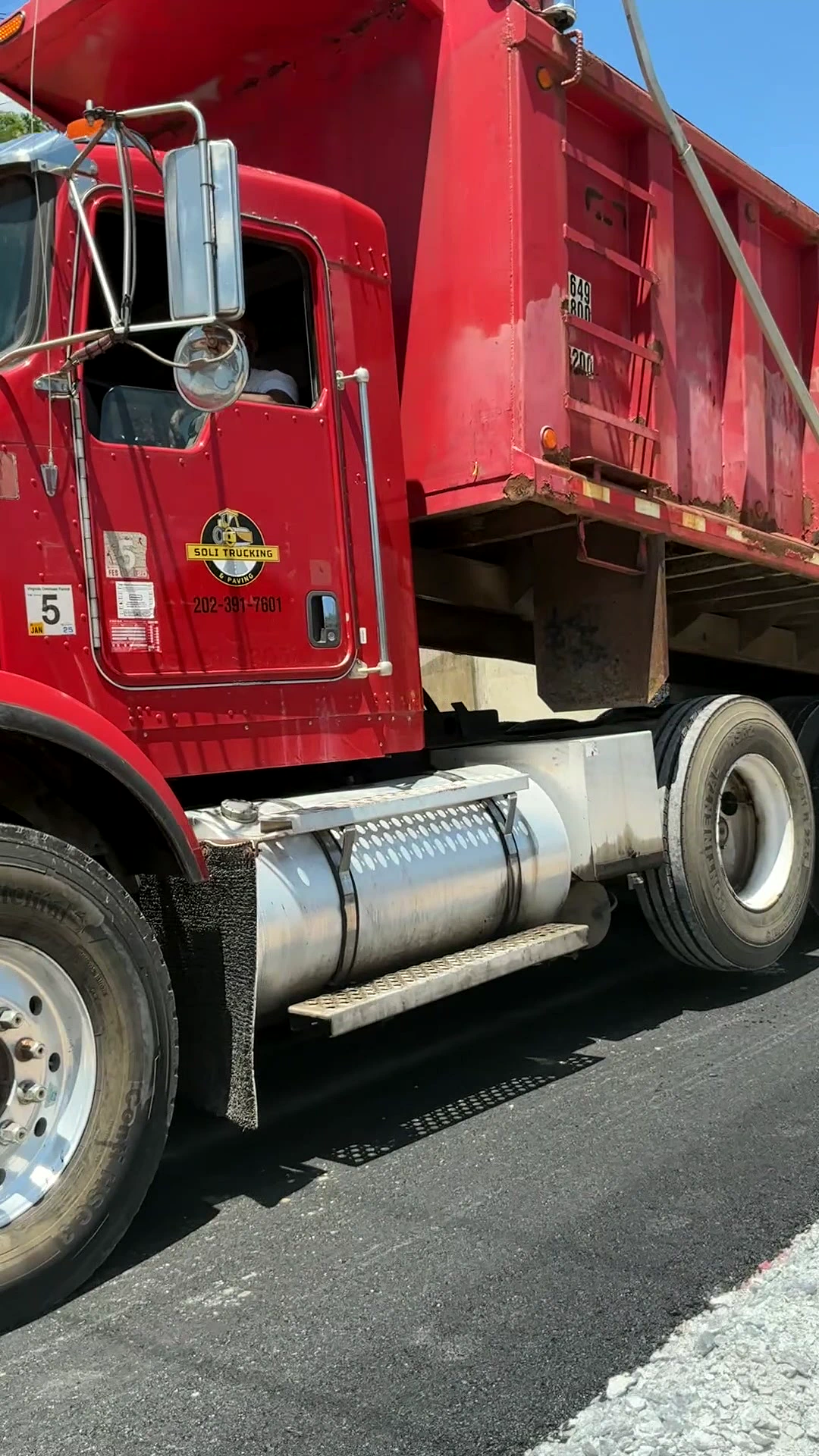 Full scene showing a Soli Trucking and Paving truck at the work site